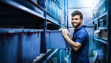 Portrait of smiling worker is working in warehouse