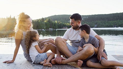 Family on the pier warm summer day having good time