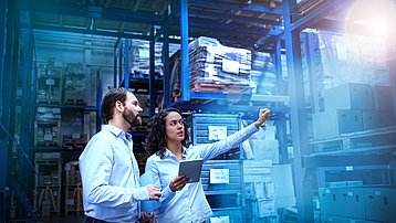 Manager and supervisor taking inventory in warehouse